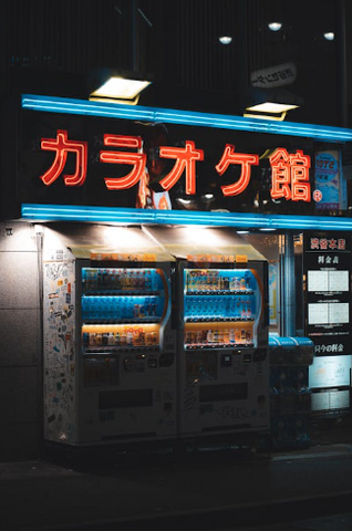 "Vending machines in Japan, lined up and offering a variety of items such as drinks, snacks, and other products, with clear Japanese labels and a modern, compact design